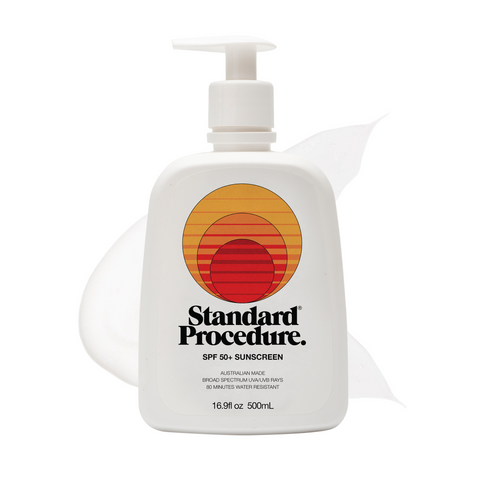 SPF 50 sunscreen for face pump bottle with a subtle lotion smear behind it on a clean white background.