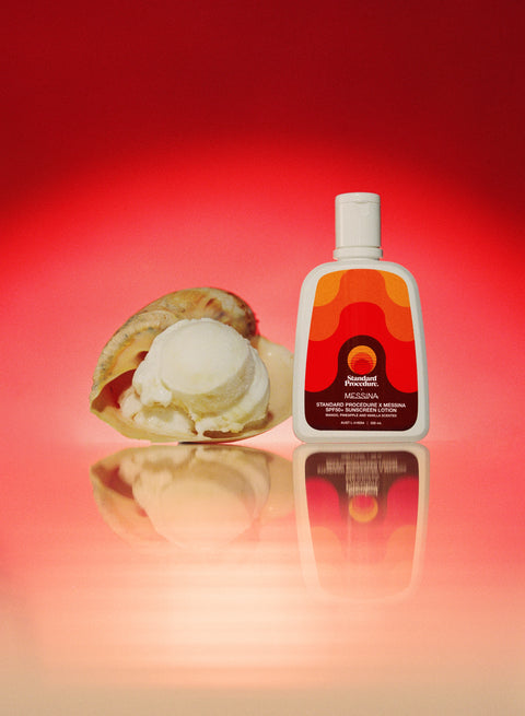 Best sunscreen with vitamin C: SPF 50 Gelato Messina–scented sunscreen bottle beside a scoop of vanilla-pineapple sorbet and a vanilla pod on a reflective surface.