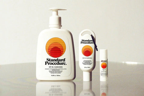TGA-approved sunscreen and lip balm set displayed on a reflective surface against a neutral background
