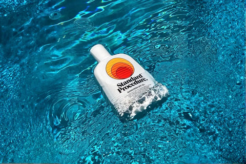 Standard Procedure best body sunscreen SPF 50+ bottle floating in a pool