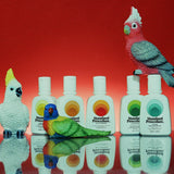 Australian mineral sunscreen bottles from Standard Procedure displayed alongside colorful Australian bird figurines against a red backdrop, highlighting vibrant, nature-inspired skincare