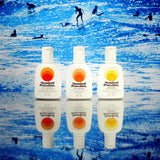 Standard Procedure SPF 50+, SPF 30, and SPF 15 sunscreens lined up against a surf scene.