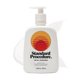 SPF 50 sunscreen for face pump bottle with a subtle lotion smear behind it on a clean white background.