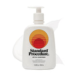 SPF 50 sunscreen for face pump bottle with a subtle lotion smear behind it on a clean white background.