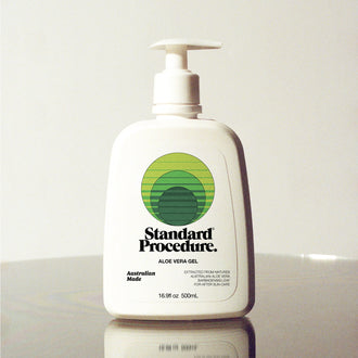 Standard Procedure Aloe Vera Gel 500ml pump bottle on a reflective surface with a neutral studio background.