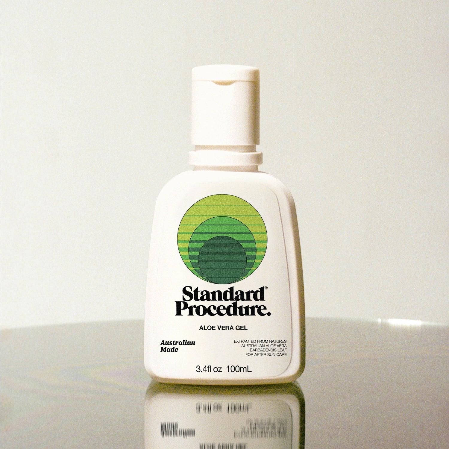 Standard Procedure Aloe Vera Gel 100ml bottle with a flip-top cap on a reflective surface.