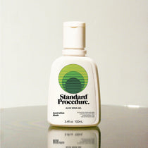 Standard Procedure Aloe Vera Gel 100ml bottle with a flip-top cap on a reflective surface.