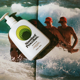 Standard Procedure Aloe Vera Gel 500ml bottle with a white pump top displayed against an ocean surf backdrop.