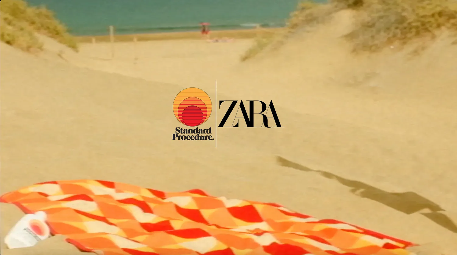 ZARA and Standard Procedure logos over a sunlit beach dune with a striped towel.