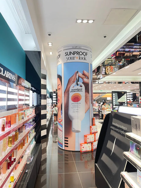 Standard Procedure SPF 50+ sunscreen display column inside a Sephora beauty store.