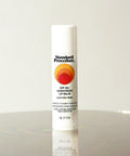Standard Procedure SPF 50 Sunscreen Lip Balm in coconut flavour on a reflective surface with a neutral background.