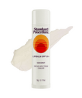 Lip protection SPF 50 balm with coconut flavor shown in front of a smear of the product on a white background.