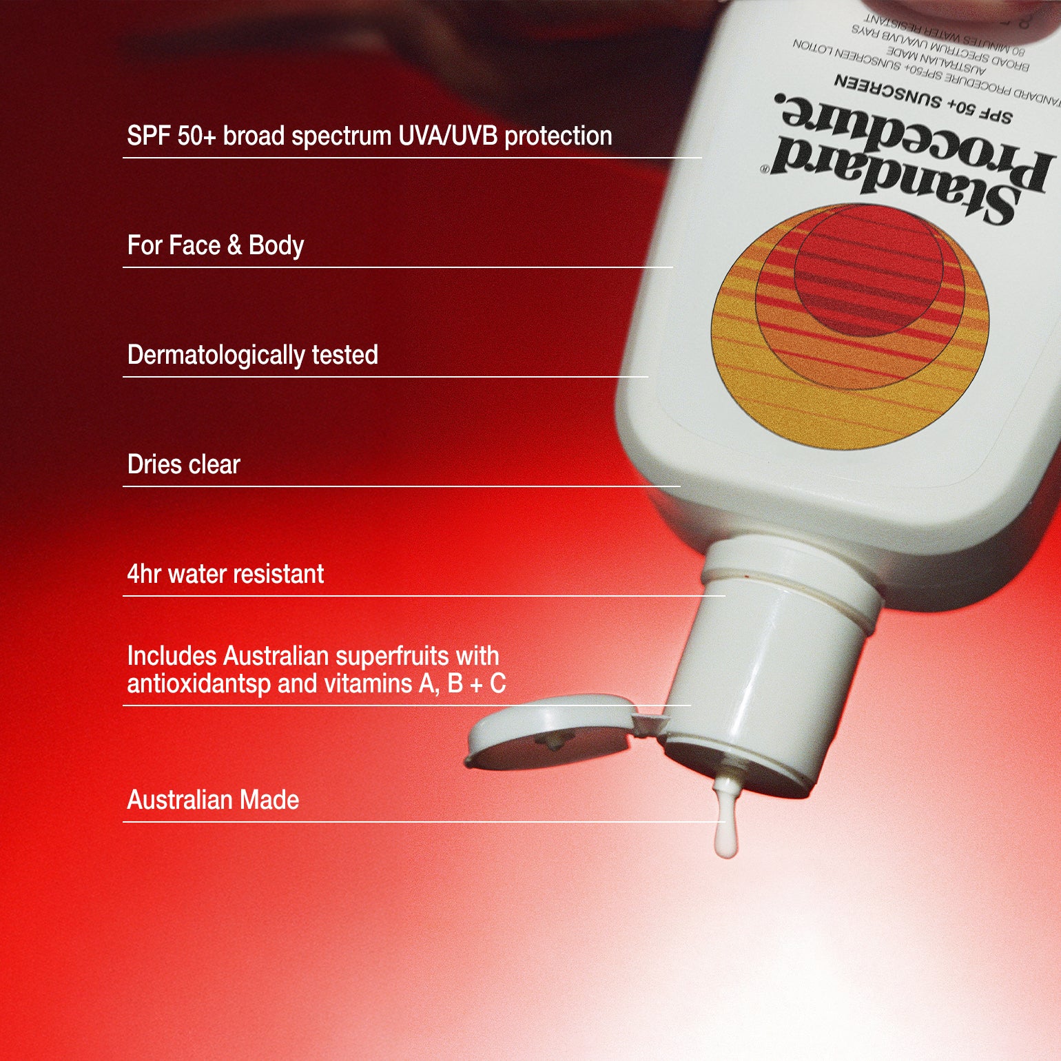 Broad spectrum sunscreen SPF 50 bottle tilted against a red gradient background with its flip-top cap open and a drop of lotion falling.