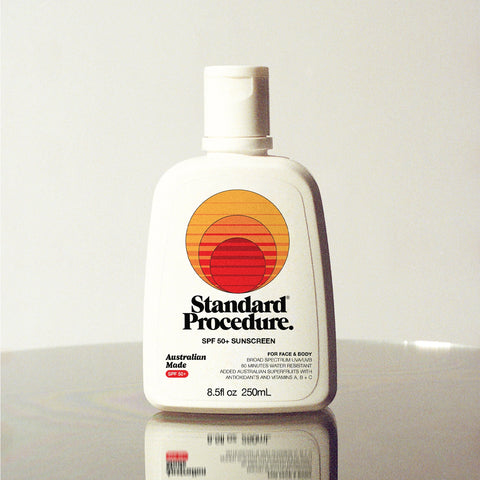 Standard Procedure SPF 50 Sunscreen 250ml bottle with a flip-top cap on a reflective surface with a grey backdrop.