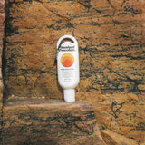 Australian made sunscreen from Standard Procedure placed against rugged rock formations, emphasizing durability, outdoor protection, and locally crafted SPF 50+ skincare