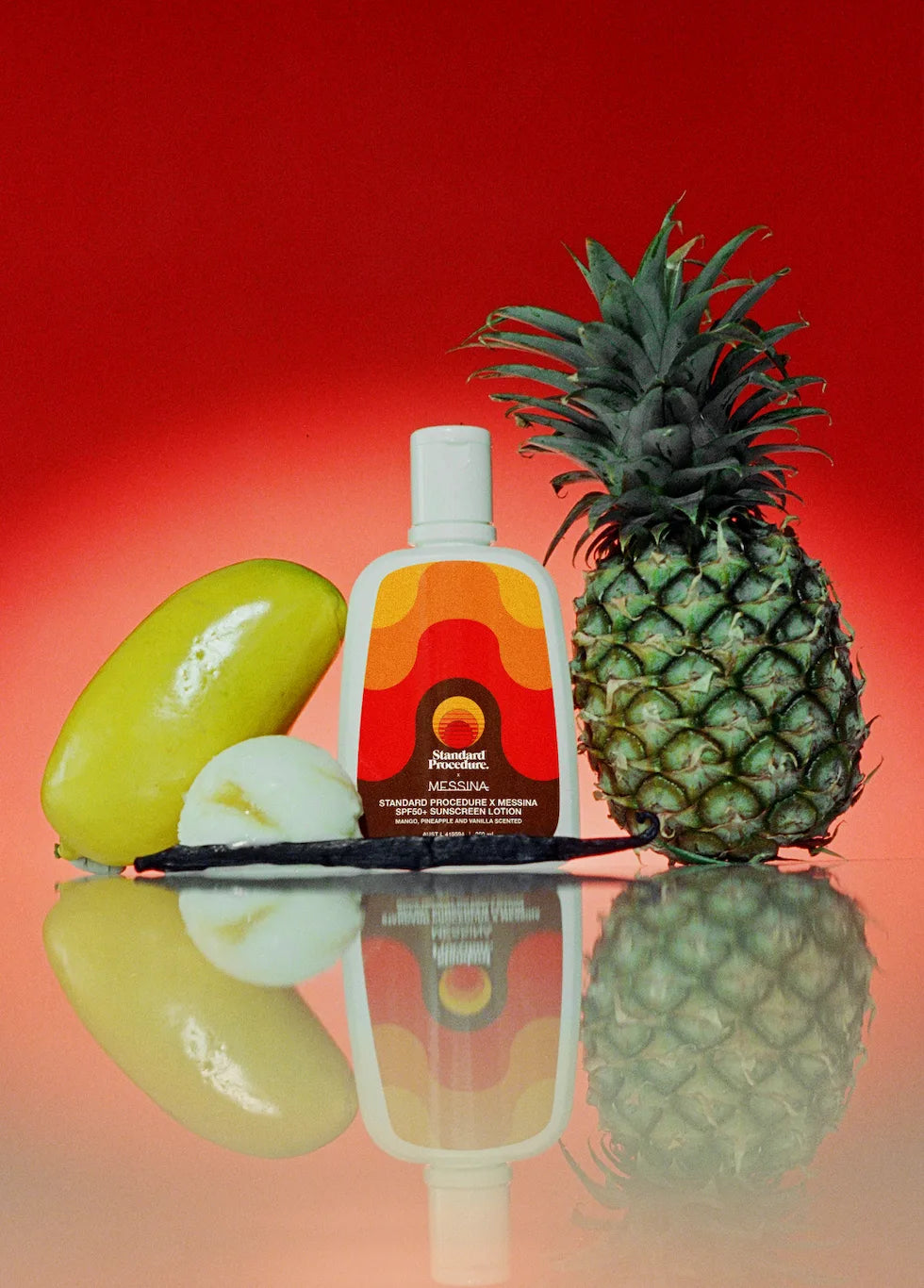 Standard Procedure x Messina SPF50+ sunscreen lotion beside mango, pineapple, and vanilla on red.