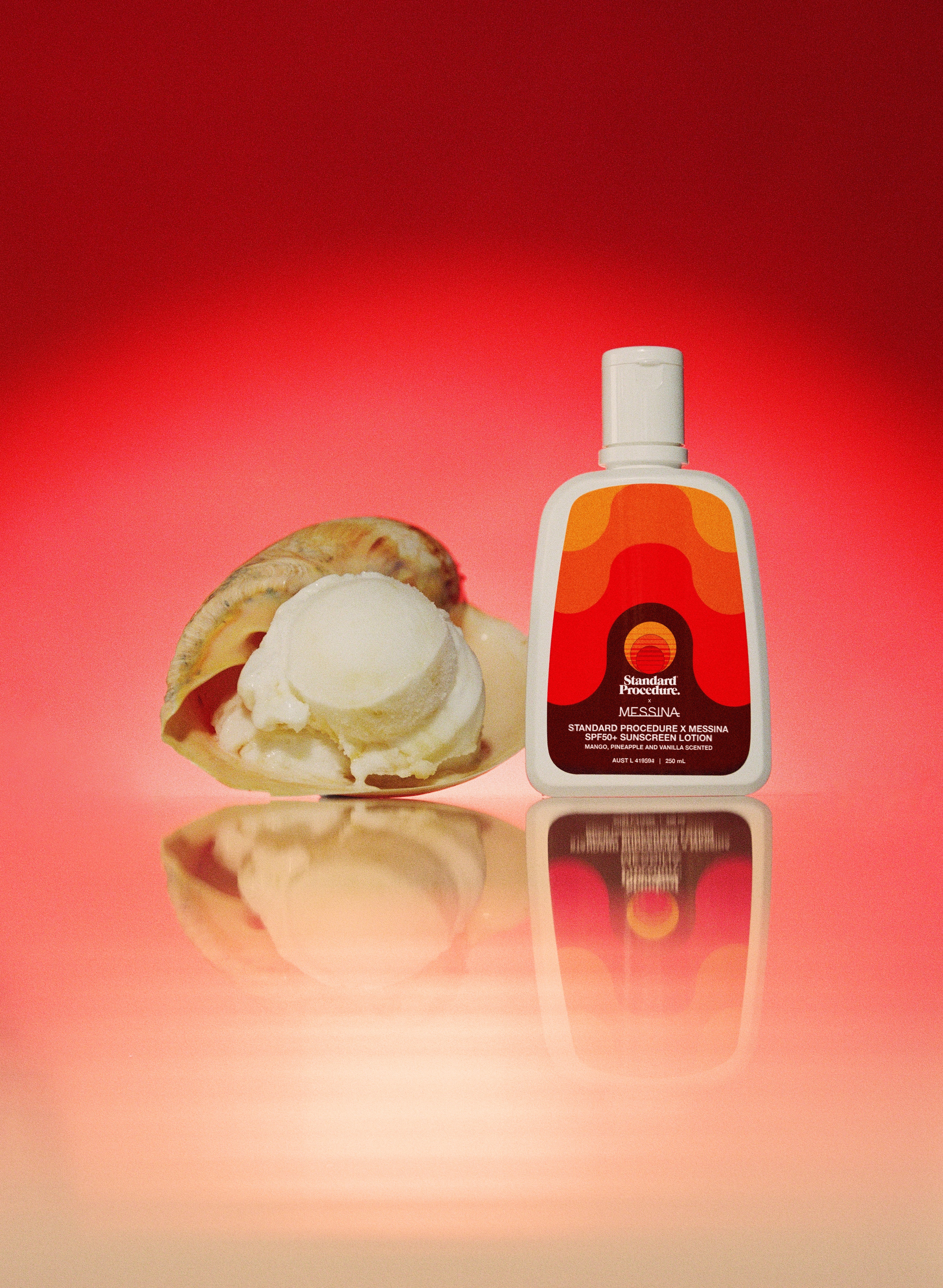 Best sunscreen with vitamin C: SPF 50 Gelato Messina–scented sunscreen bottle beside a scoop of vanilla-pineapple sorbet and a vanilla pod on a reflective surface.