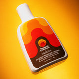 body sunscreen spf 50 bottle angled against a bright yellow background