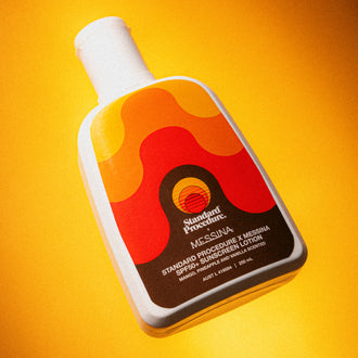body sunscreen spf 50 bottle angled against a bright yellow background