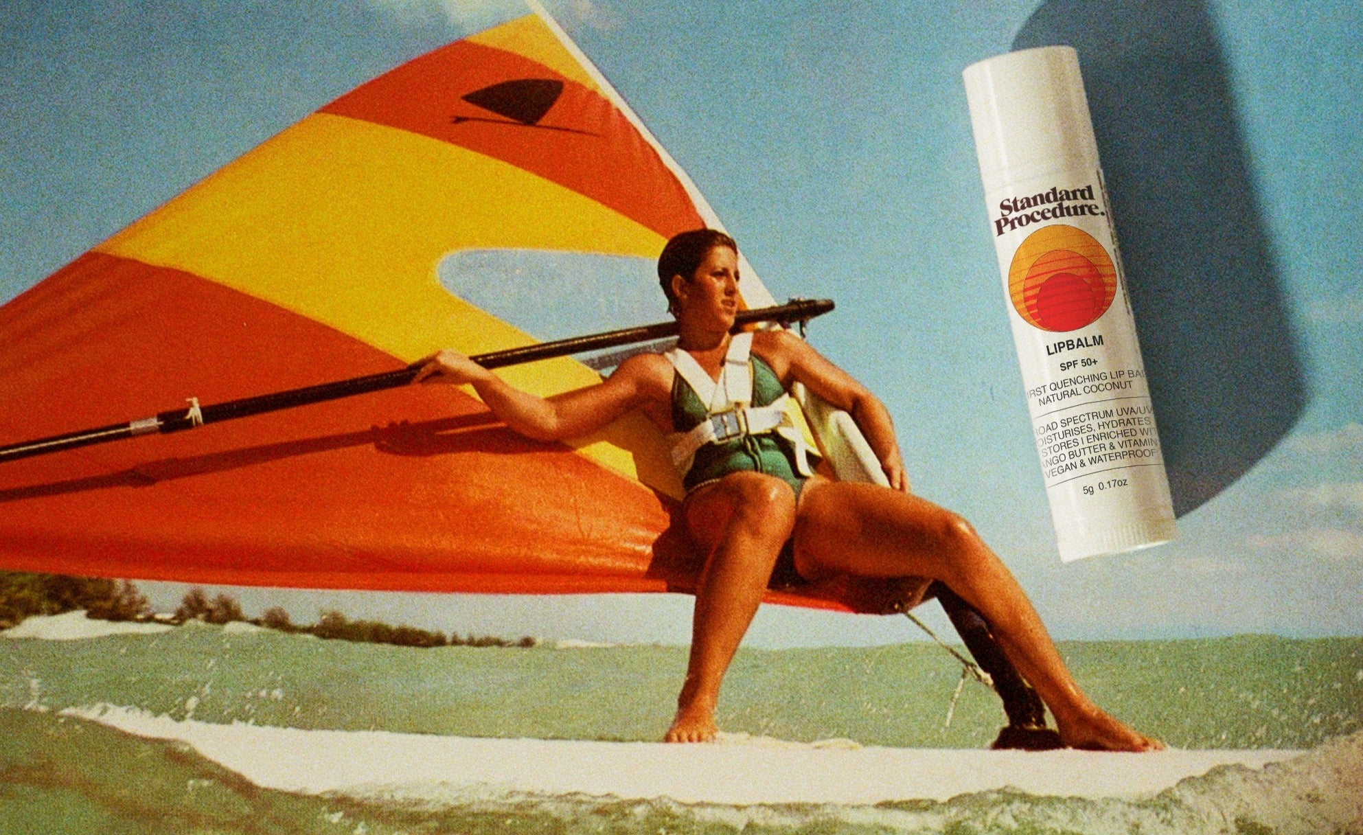 Lip balm with vitamin C and SPF shown beside a woman windsurfing on the ocean under a bright sunny sky.