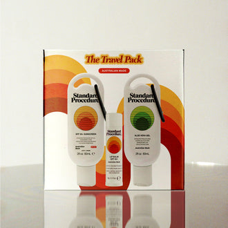Standard Procedure Travel Pack containing SPF 50 Sunscreen, Aloe Vera Gel, and Lip Balm in a retro-styled gift box.