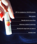 SPF 50 lip balm held by hand with text highlighting its protective, hydrating, and natural ingredient benefits.
