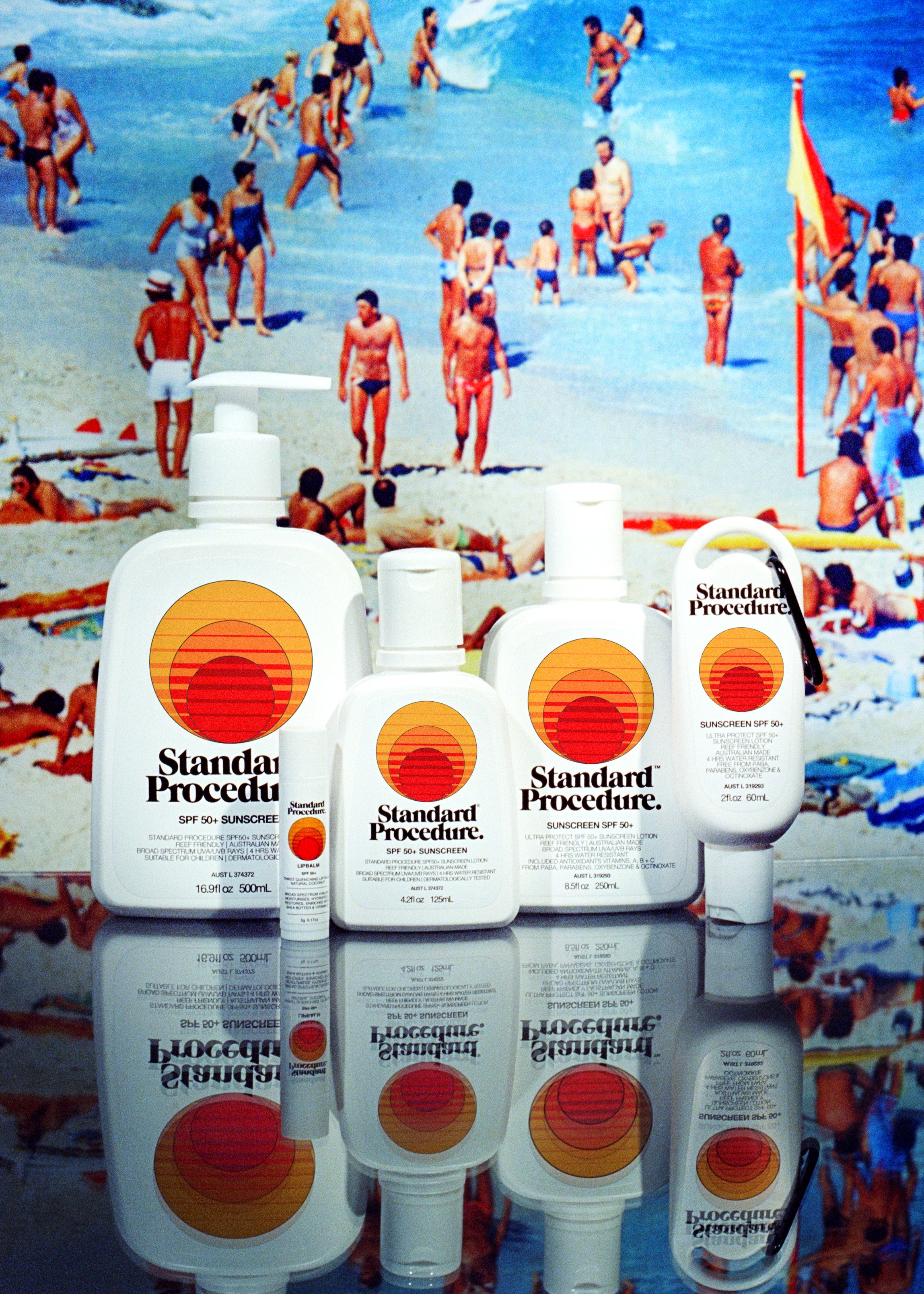 Standard Procedure SPF 50+ sunscreen range lined up against a retro Australian beach poster.