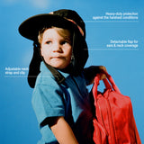 Small surf hat worn by a young child holding a red backpack, featuring adjustable neck strap, detachable flap for sun protection, and lightweight coverage for outdoor play
