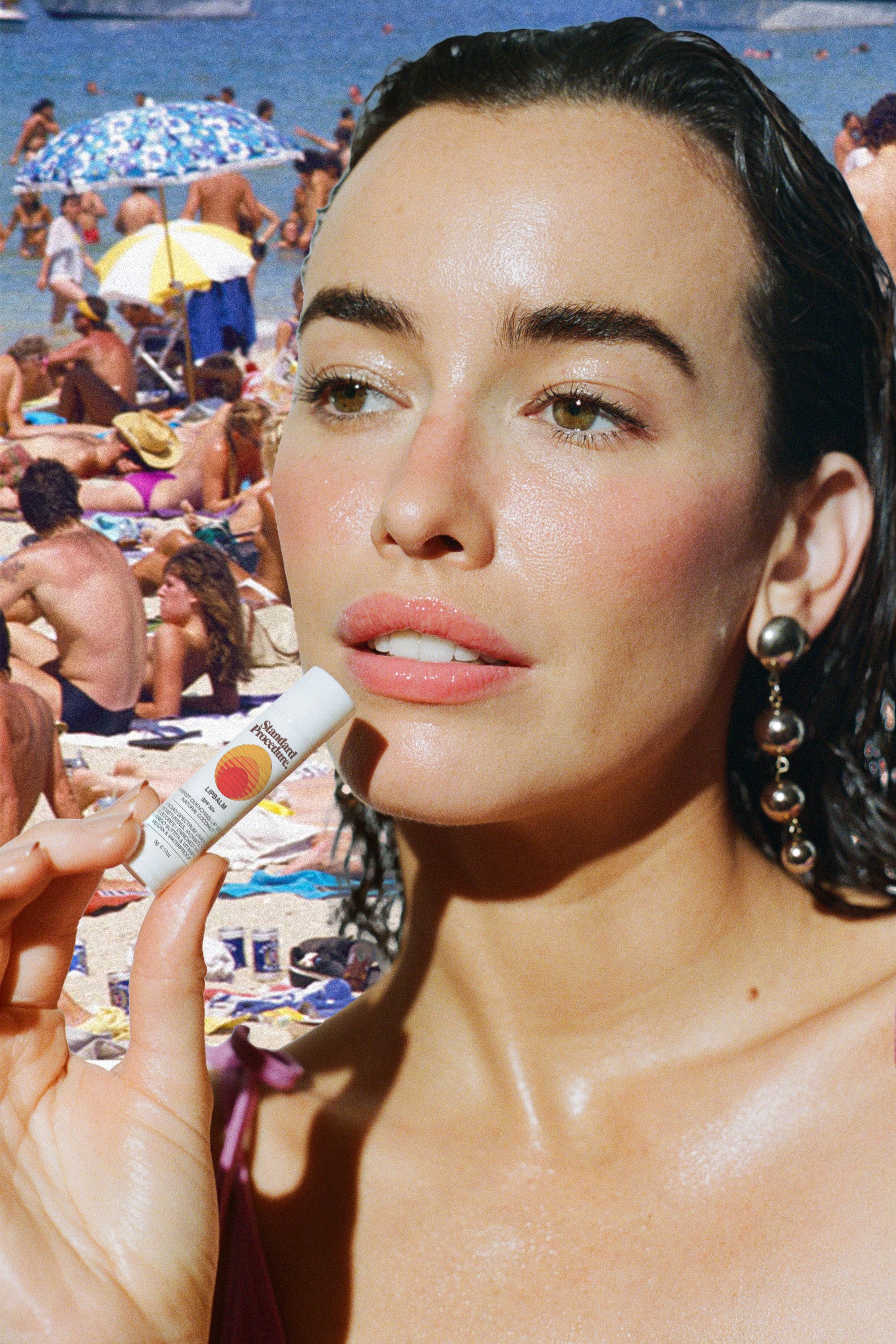 SPF 50 lip balm held by a woman at the beach with a crowd of sunbathers in the background.