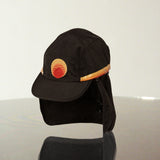 Black surf hat displayed against a neutral background, featuring a wide brim, neck flap, and signature Standard Procedure logo for full sun coverage and outdoor protection