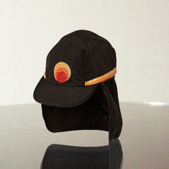 Black surf hat displayed against a neutral background, featuring a wide brim, neck flap, and signature Standard Procedure logo for full sun coverage and outdoor protection